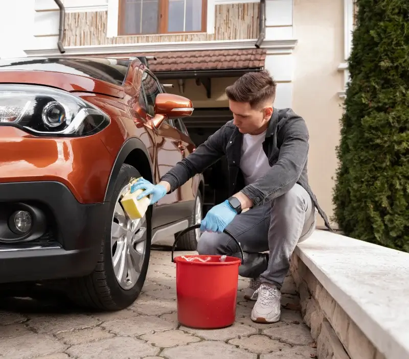 Lavage auto à domicile Feuguerolles-Bully : professionnel intervenant sur un véhicule